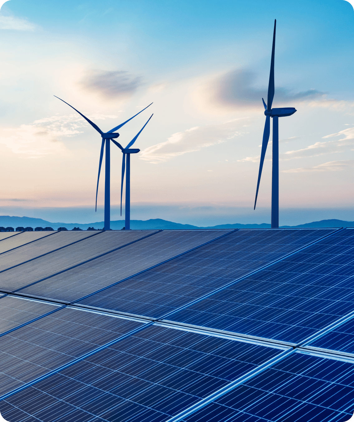 Solar panels and wind turbines at sunset.