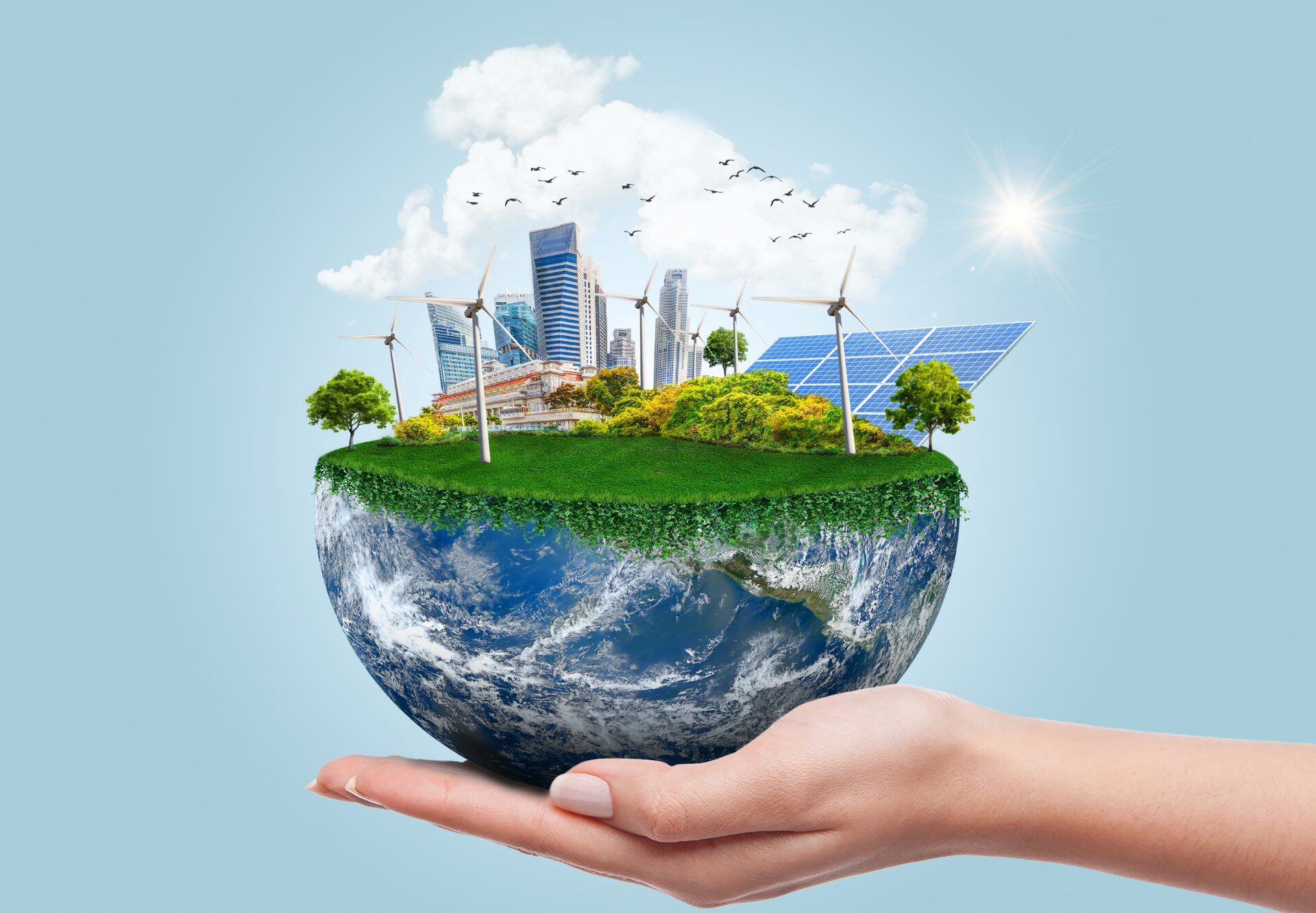 Hand holding sustainable city on globe.